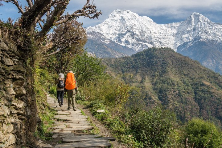 Zwei Wanderer und der Blick auf die Annapurna im Hintergrund Zwei Wanderer und der Blick auf die Annapurna im Hintergrund