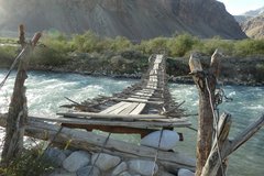 Abenteuerliche Holzbrücke über reissenden Fluss im Pamir